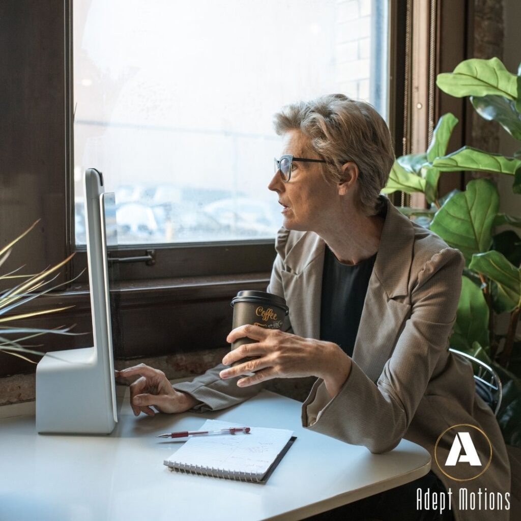 senior entrepreneur sitting at computer marketing her business