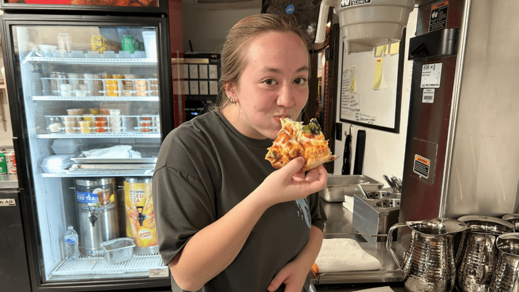 Mamma Mia Italian Restaurant in Abingdon, VA Employee Eating Pizza.