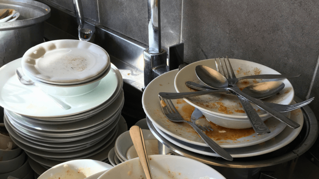 Dirty Dishes in a Business Office Kitchen Sink.